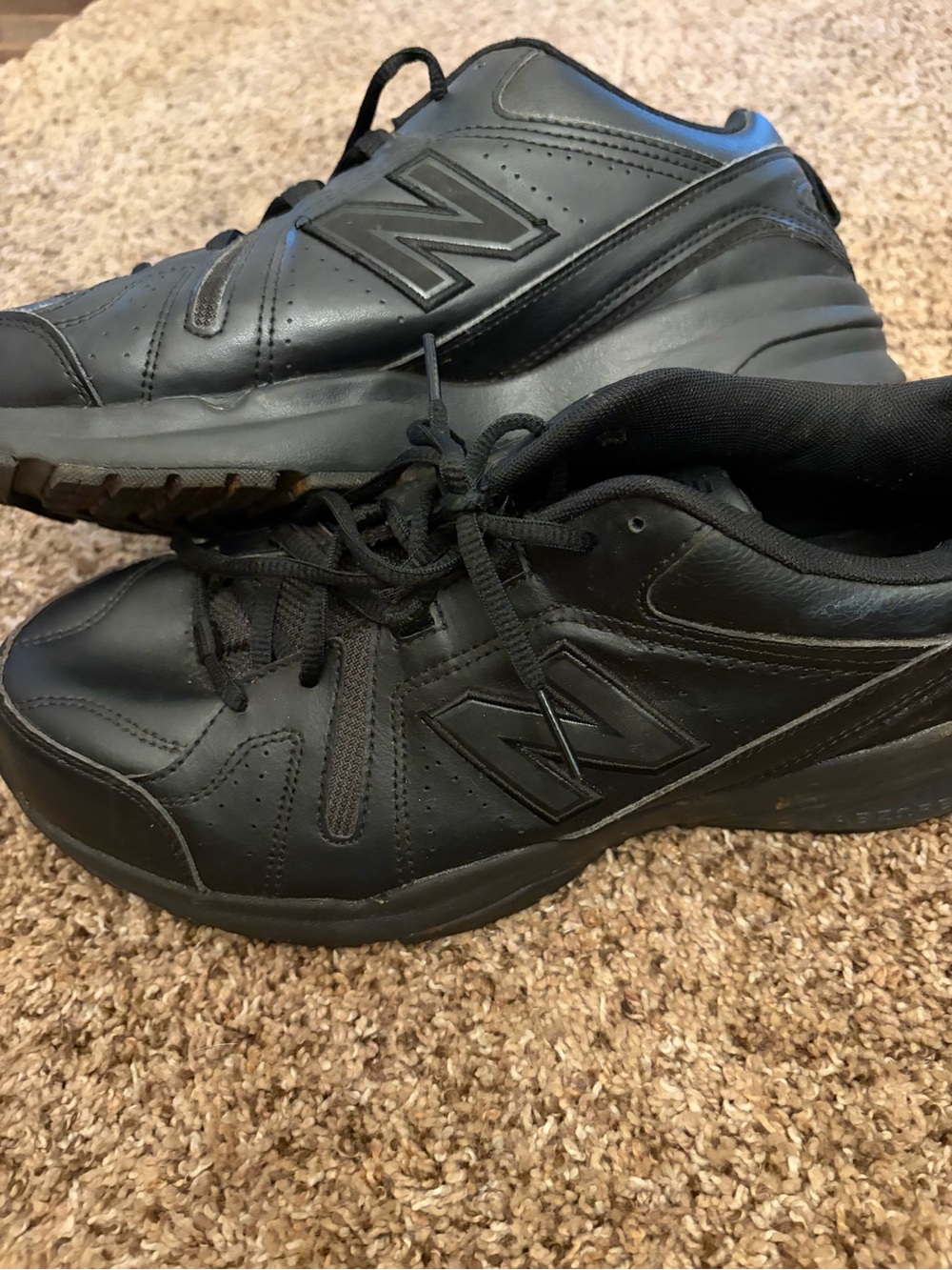 New Balance 608v5 training shoes in black featuring a leather upper.